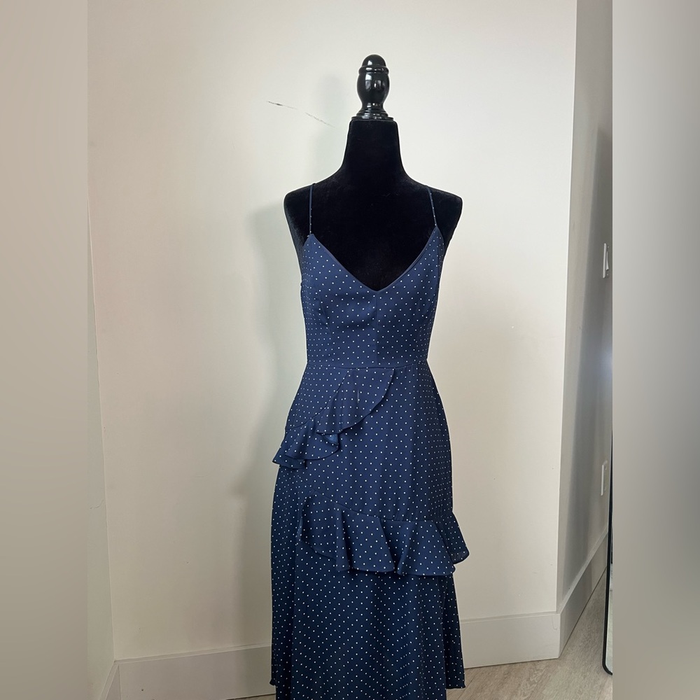Perfect for the country club! This polka dot ruffled dress is all class.